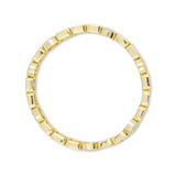 Gold ring with a geometric design on a white background