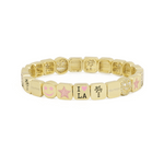 Gold bracelet with various charms on a white background