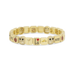 Gold bracelet with various charms on a white background