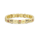 Gold bracelet with various charms on a white background