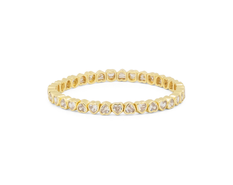 Yellow gold tennis bracelet with heart-shaped clear stones along flexible band