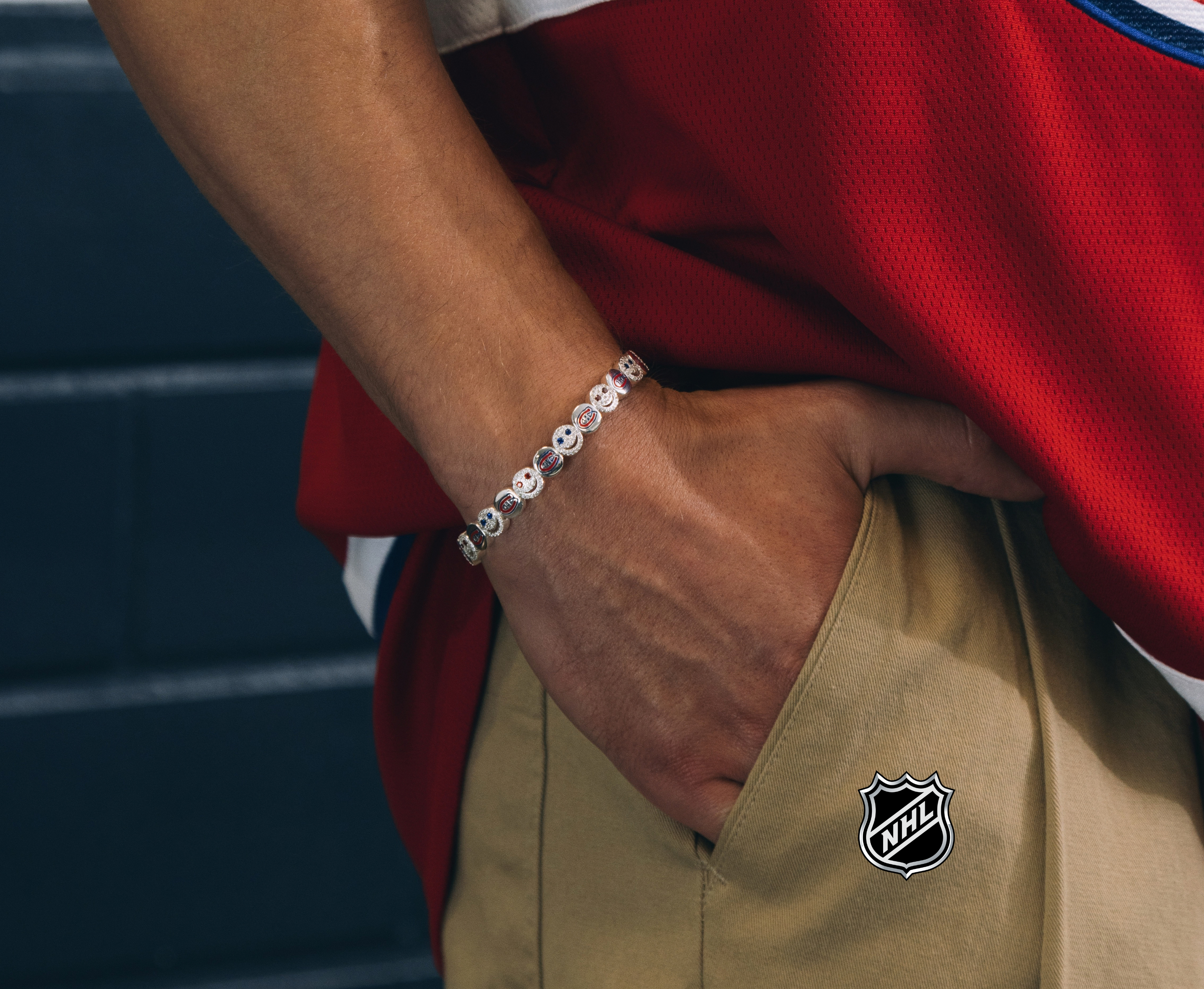 Silver-tone NHL charm bracelet with round blue team-logo discs
