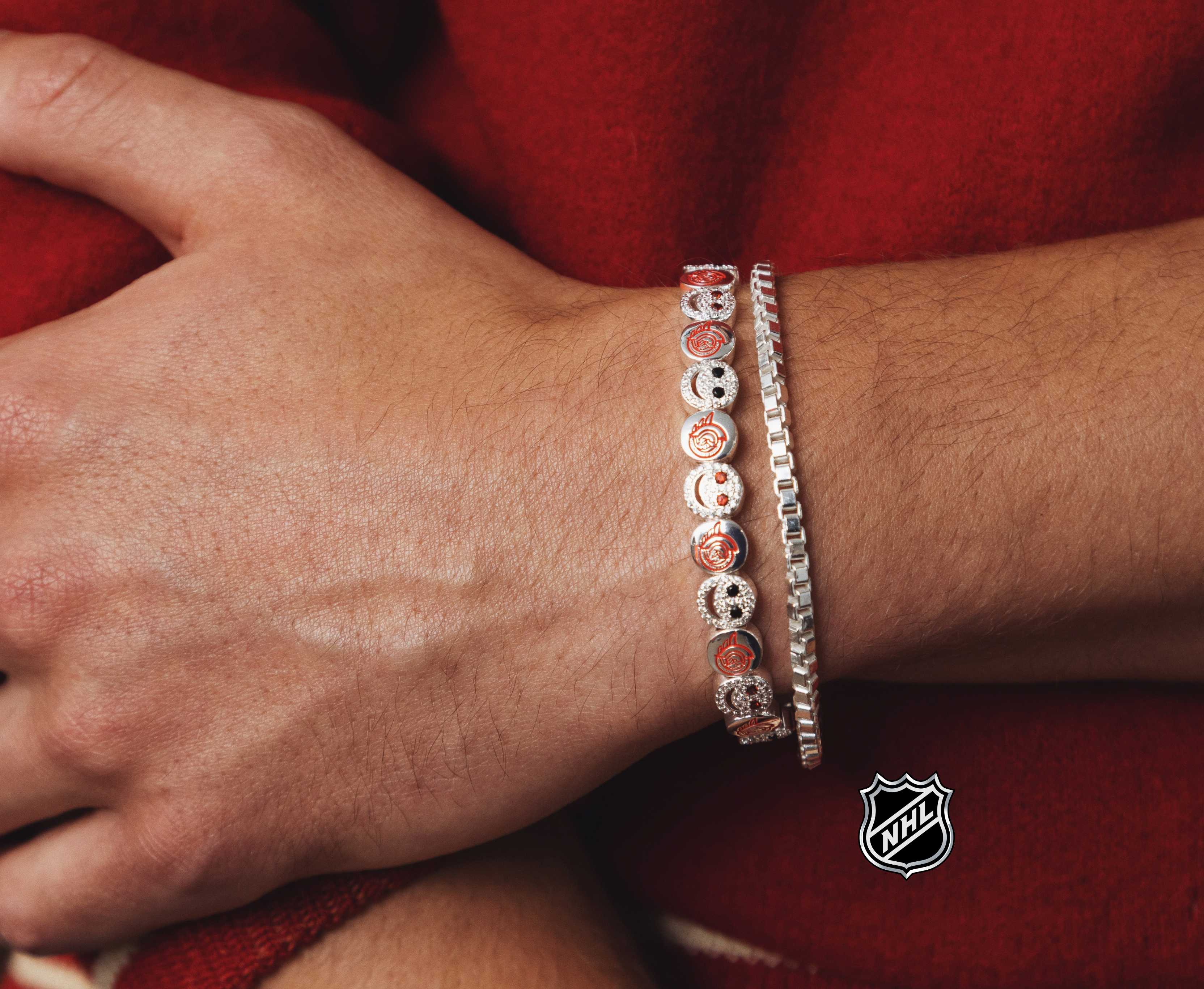 Silver-tone NHL charm bracelet with red-and-white round team-logo medallions