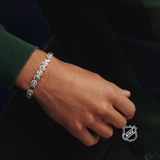 Silver-tone NHL charm bracelet with repeating round team-logo discs