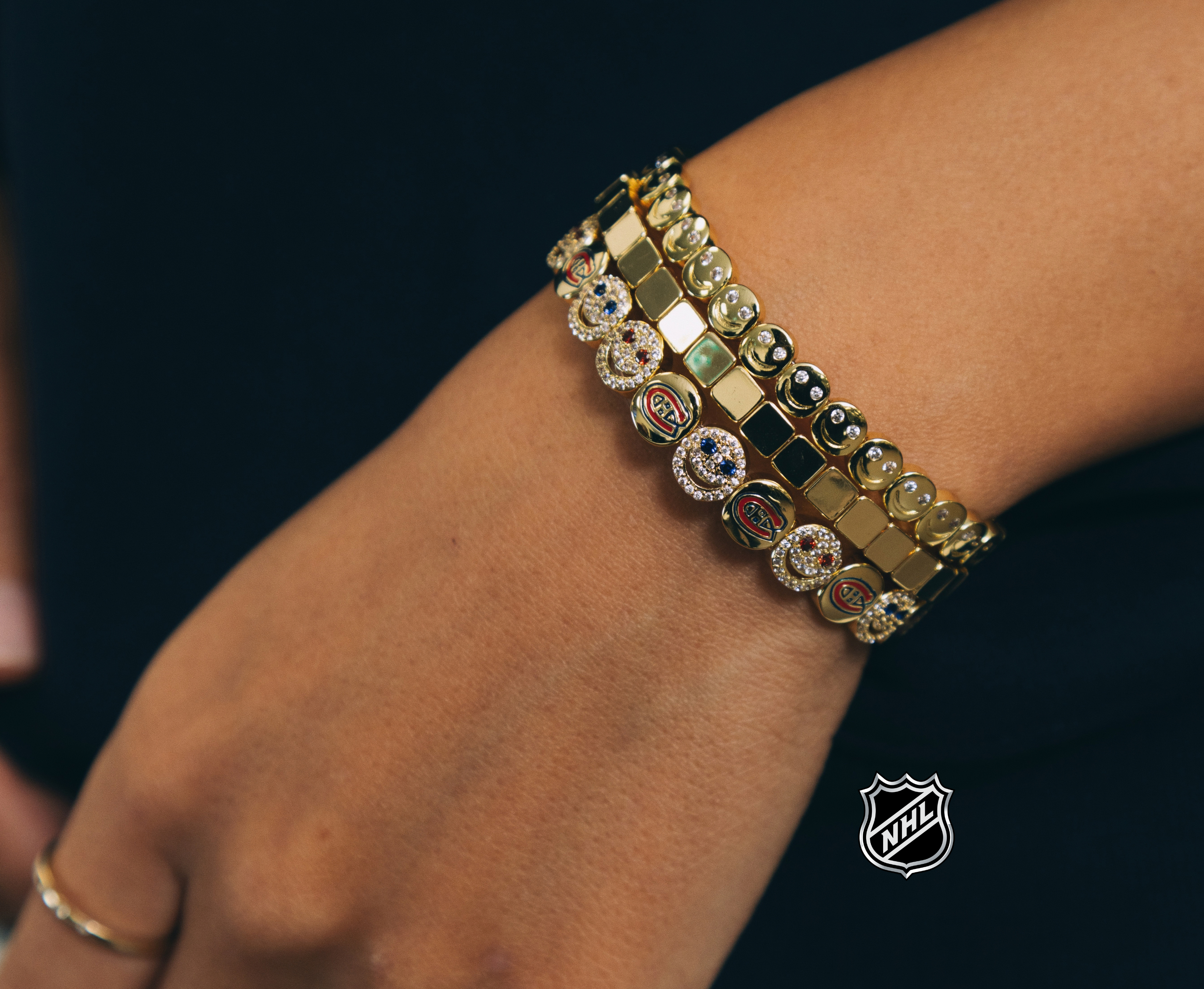 Gold-tone NHL charm bracelet with rectangular links and round team-logo stones