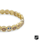 Gold NHL® bracelet with team-logo charm beads, shown from side angle