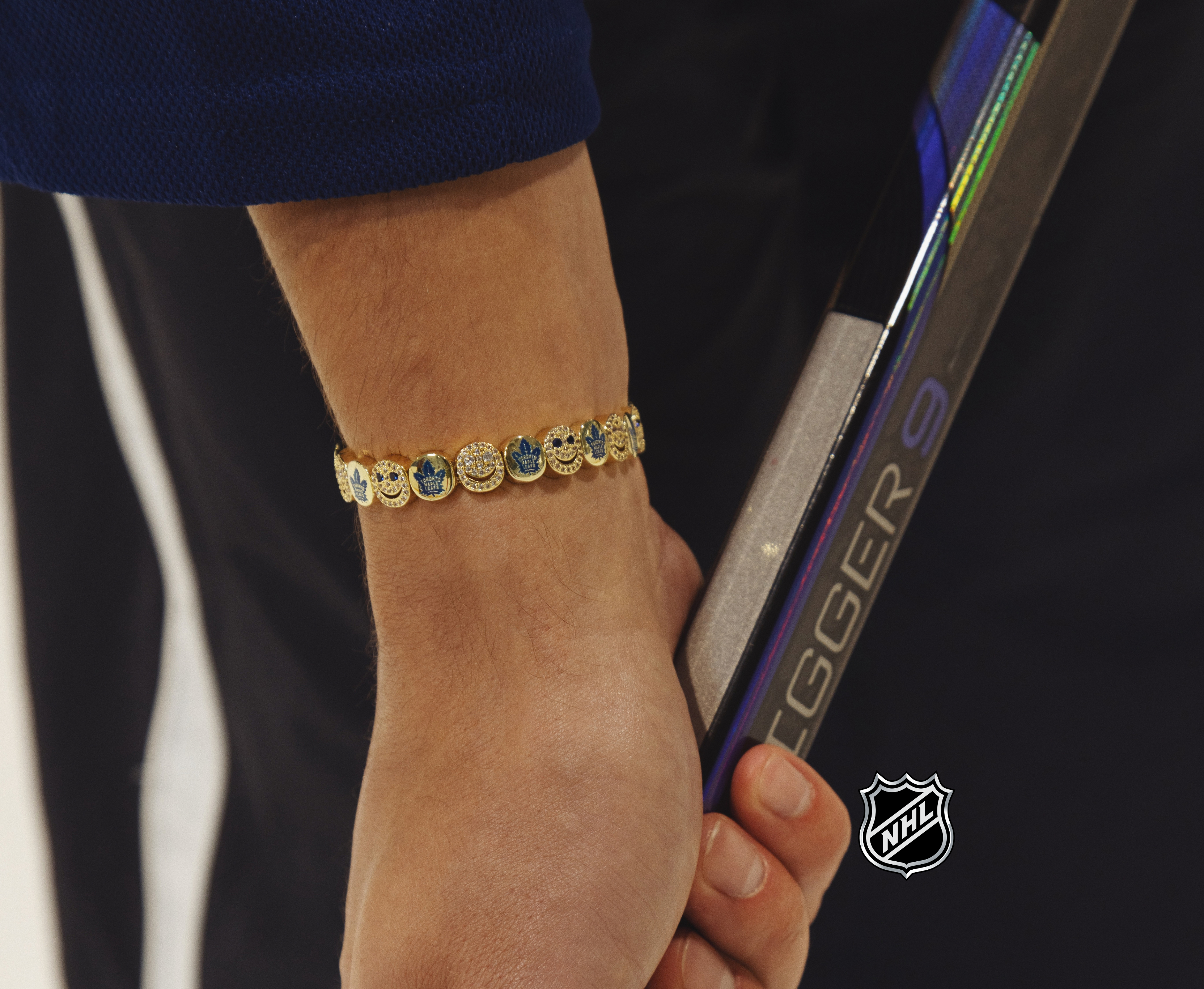 NHL® bracelet, gold-tone link with round logo medallions on wrist
