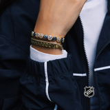 Silver-tone charm bracelet with small round team-logo discs on layered chain