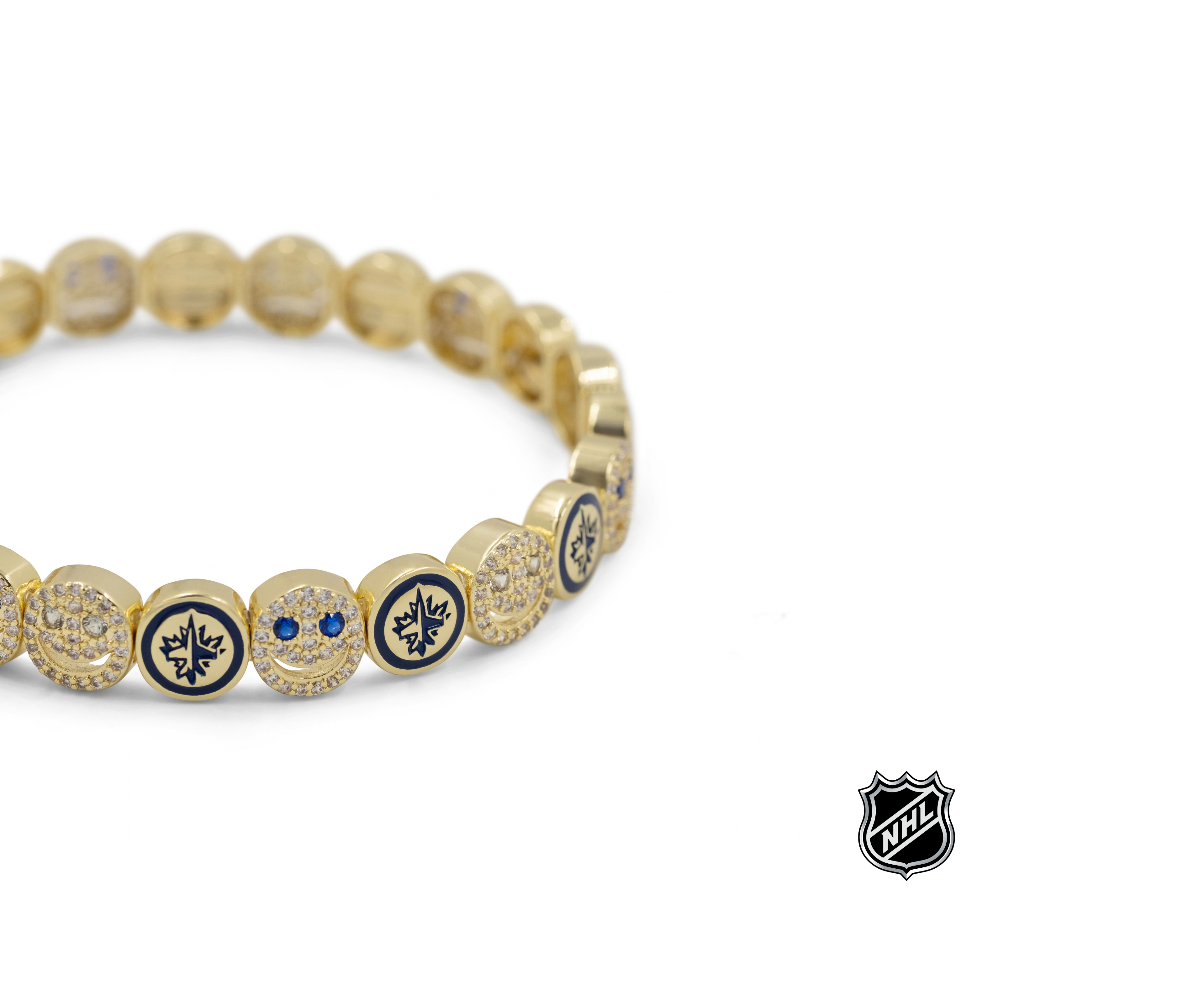 Gold-tone bracelet with blue enamel crest discs and clear rhinestone beads