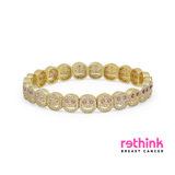 Yellow gold pavé bracelet with oval links and pink stone accents