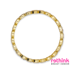 Gold cuff bracelet with ridged arc design, seamless circular band.