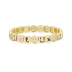 Gold bracelet with various charms on a white background