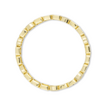 Gold ring with a geometric design on a white background