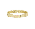 Gold bracelet with various charms on a white background